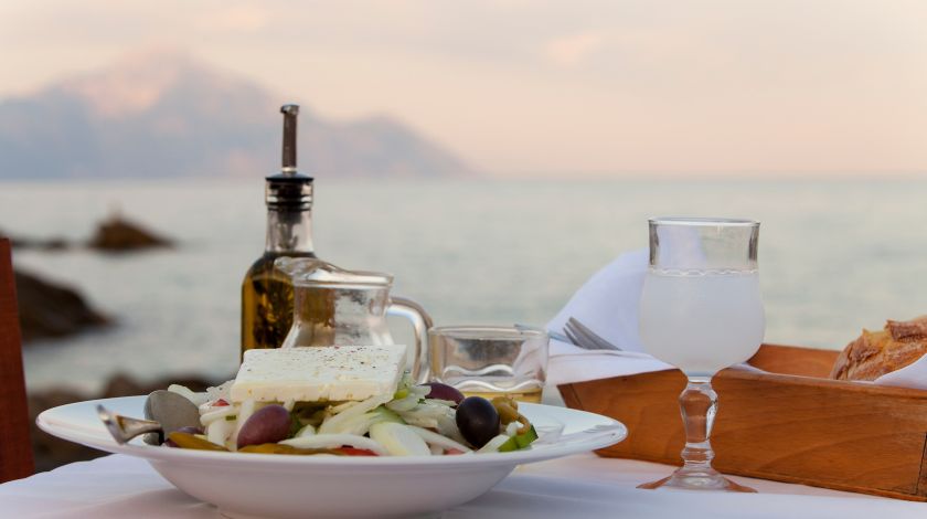a-white-greek-salad-bowl-with-a-sea-view-background